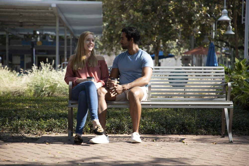 a couple sitting on an outdoor bench