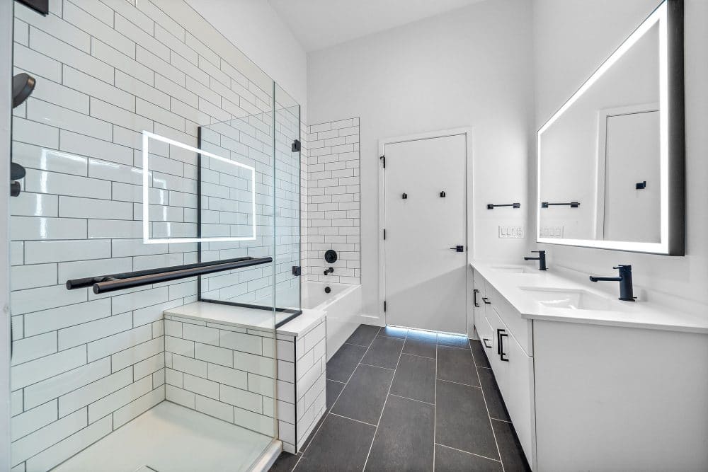 apartment bathroom featuring a deep soaking tub and glass walk-in shower