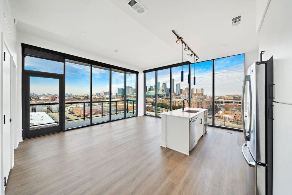open-concept apartment with floor-to-ceiling windows at Forth at Navigation