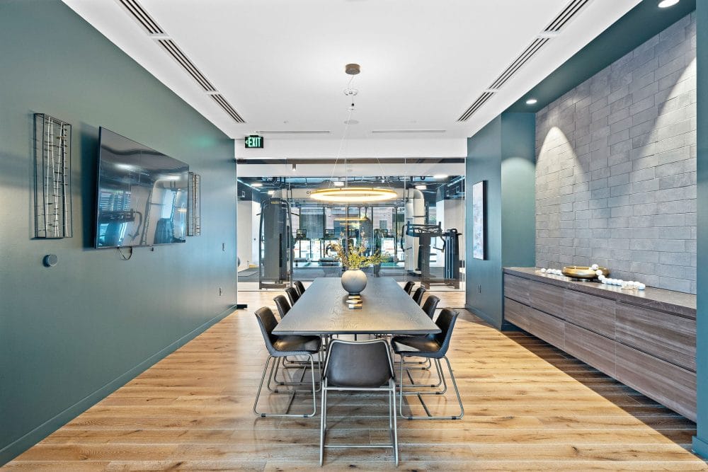 conference table next to a mounted tv
