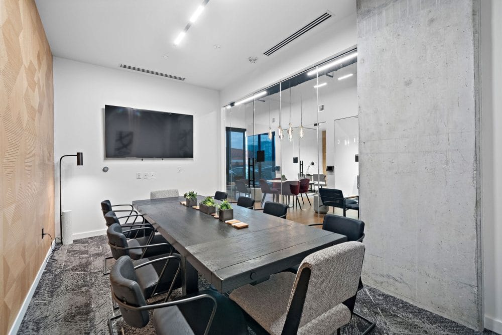 business center with a conference table and mounted tv